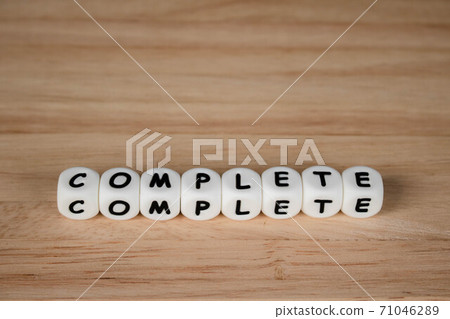 Dice the word "complete". Text dice cube concept / Letter dices alphabet on wooden background. Block of alphabet studded on the floor. coppy space. 71046289