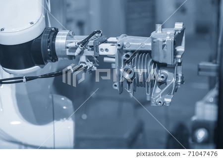 The robotics arm gripping the motorcycle engine parts. 71047476