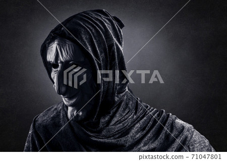 Portrait of a scary witch in hooded cloak Portrait of a scary witch in hooded cloak 71047801