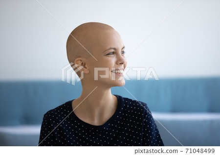 Close up head shot smiling hairless woman looking to aside 71048499