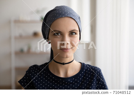 Head shot portrait attractive hairless woman wearing head scarf Head shot portrait attractive hairless woman wearing head scarf 71048512