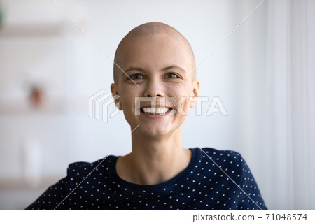 Head shot portrait smiling hairless woman looking at camera Head shot portrait smiling hairless woman looking at camera 71048574