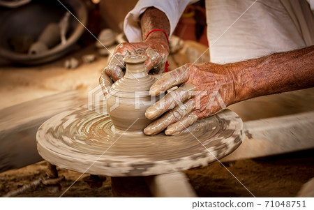 Potter at work makes ceramic dishes.Rajasthan. 71048751