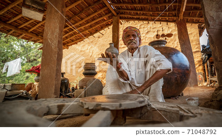 Potter at work makes ceramic dishes. Rajasthan. Potter at work makes ceramic dishes. Rajasthan. 71048792