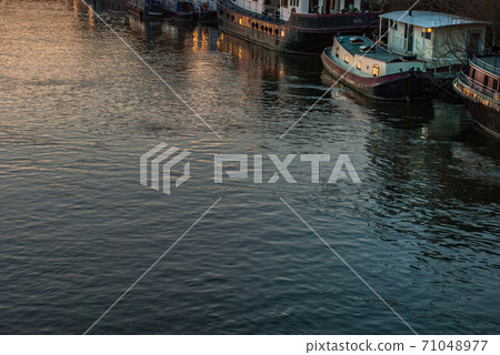 Many boats that are parked on the Thames Many boats that are parked on the Thames 71048977