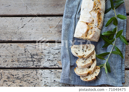 Ciabatta bread with olive branch. Wooden background. Copy space. Top view. Ciabatta bread with olive branch. Wooden background. Copy space. Top view. 71049475