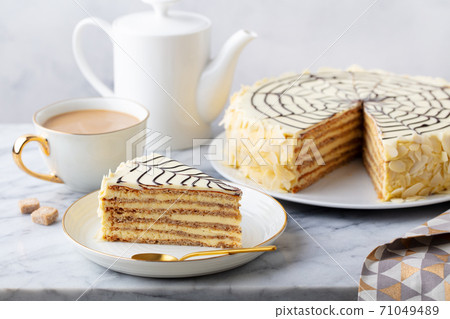 Traditional Hungarian Esterhazy cake, torte with cup of coffee. Marble background. Close up. 71049489