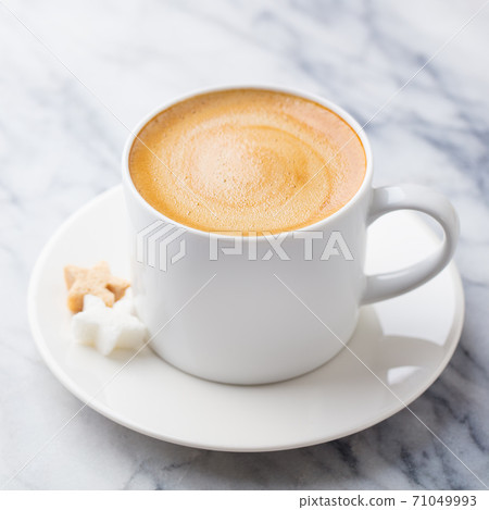 Coffee, espresso in white cup. Marble background. Close up. Coffee, espresso in white cup. Marble background. Close up. 71049993