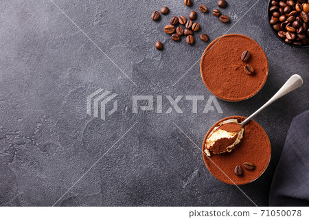 Tiramisu dessert in glasses. Dark grey background. Copy space. Top view. Tiramisu dessert in glasses. Dark grey background. Copy space. Top view. 71050078