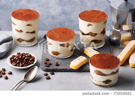 Tiramisu dessert in glass on table. Confectionery shop menu. Grey background. 71050081