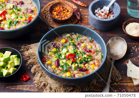 Vegetable quinoa soup, stew with avocado, corn, beans. South American traditional dish. 71050478