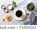 Cup of black coffee with coffee beans on marble table. Close up. Top view. 71050503