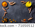 Fresh turmeric, curcuma, tumeric roots, dried slices, powder and golden milk. Dark background. Copy space. Top view. 71050512