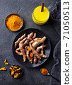 Fresh turmeric, curcuma, tumeric roots, dried slices, powder and golden milk. Dark background. Top view. 71050513