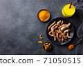 Fresh turmeric, curcuma, tumeric roots, dried slices, powder and golden milk. Dark background. Copy space. Top view. 71050515