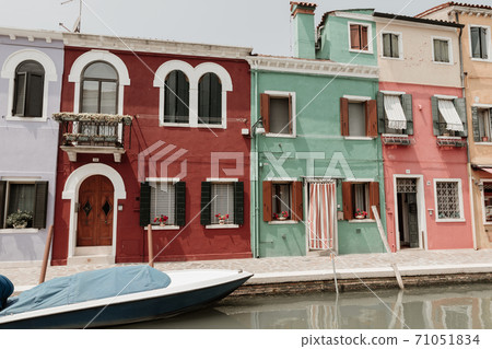 Panoramic view of coloured homes and water canal with boats in Burano Panoramic view of coloured homes and water canal with boats in Burano 71051834