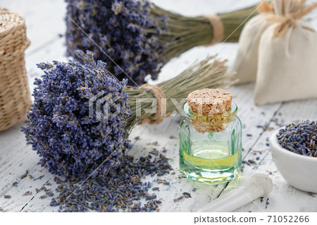 Lavender essential oil bottle, mortar, sachet bags and bouquets of dried lavender flowers. Lavender essential oil bottle, mortar, sachet bags and bouquets of dried lavender flowers. 71052266