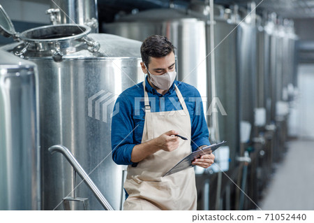 Engineer inspect plant, technician working maintenance and record data on check list 71052440