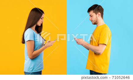 Portrait of young couple using their mobile phones Portrait of young couple using their mobile phones 71052646