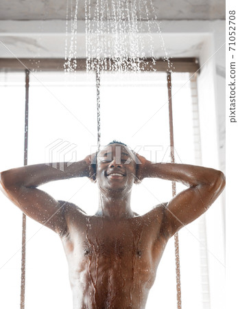 Happy African American Man Taking Morning Shower Indoor, Vertical Shot 71052708