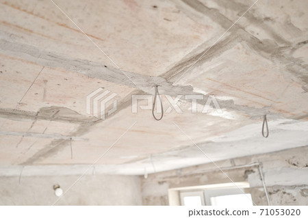 Installation hidden wiring for room lighting. External spots. Professional draft electrical wiring in house or apartment during repair. Concept distribution of electricity in apartment, safety 71053020