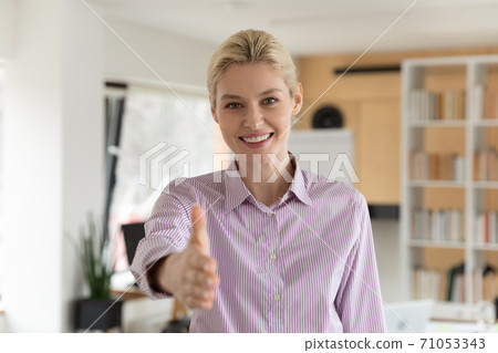 Pleasant young female hr manager reaching out hand. Pleasant young female hr manager reaching out hand. 71053343