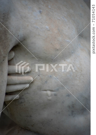 Jesus's wound and Mary's hand touching him, stone cemetery statue. Jesus's wound and Mary's hand touching him, stone cemetery statue. 71054143