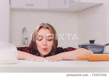 partial view of young woman in lingerie preparing dough in kitchen. 71055548