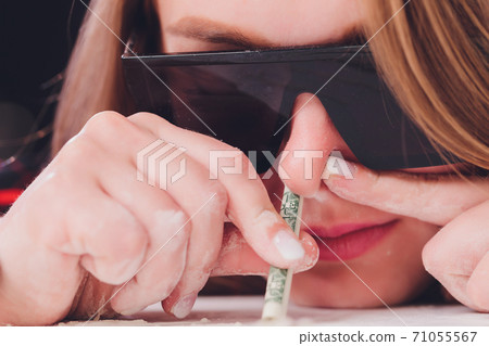 Swag girl sniffing cocaine imitation, flour . blonde Woman stoned. White background. Swag girl sniffing cocaine imitation, flour . blonde Woman stoned. White background. 71055567