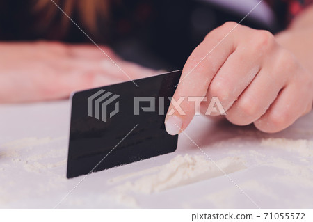 Swag girl sniffing cocaine imitation, flour . blonde Woman stoned. White background. 71055572