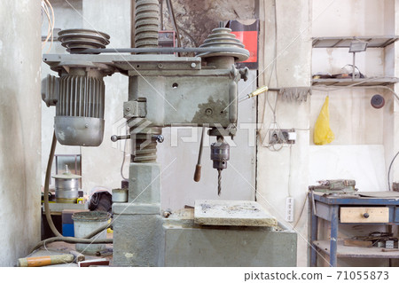 Old drilling machine in the production hall. Old drilling machine in the production hall. 71055873