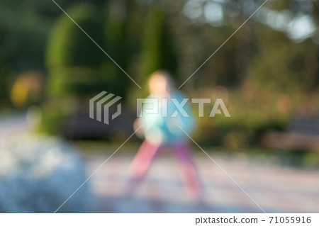 Little kid have fun jumping in the park. 71055916