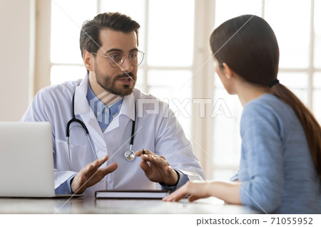 Concentrated attentive therapist professional consulting client in office 71055952