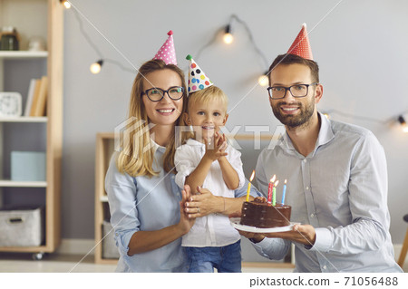 Portrait of happy parents and their little birthday boy at home looking at camera and smiling Portrait of happy parents and their little birthday boy at home looking at camera and smiling 71056488
