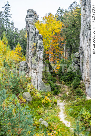 Sandstone rock formation in vibrant autumn forest Sandstone rock formation in vibrant autumn forest 71058057