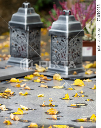 Lanterns on granite tombstone. Old town graveyard in forest park Lanterns on granite tombstone. Old town graveyard in forest park 71059013