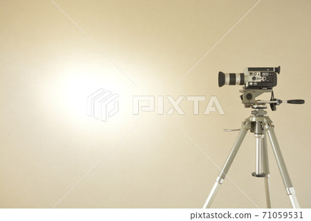 Layout with antique 8mm film camera and French tripod (bright walls and copy space) Layout with antique 8mm film camera and French tripod (bright walls and copy space) 71059531