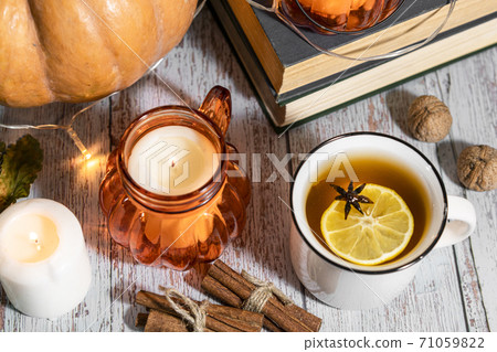 Thanksgiving background, composition with pumpkins, dry autumn leaves, candles on wooden background. Thanksgiving background, composition with pumpkins, dry autumn leaves, candles on wooden background. 71059822