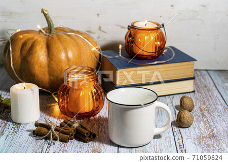 Thanksgiving background, composition with pumpkins, dry autumn leaves, candles on wooden background. Thanksgiving background, composition with pumpkins, dry autumn leaves, candles on wooden background. 71059824