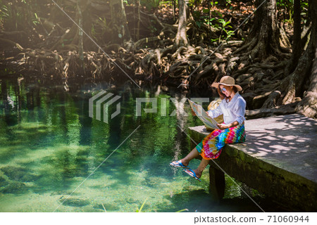 Asian women travel relax, travel nature in the holiday. women enjoying Sitting and watching the travel map the lake mangrove forest. tha pom-klong-song-nam at krabi. summer, Map 71060944