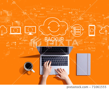 Backup concept with person using a laptop Backup concept with person using a laptop 71061555