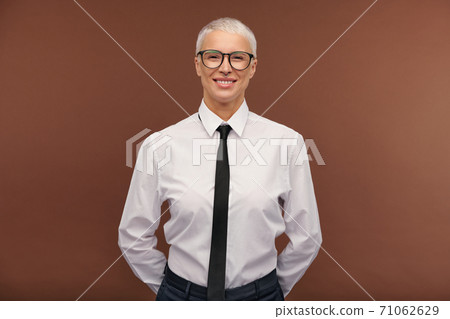 Cheerful manlike blond female in formalwear and eyeglasses looking at you Cheerful manlike blond female in formalwear and eyeglasses looking at you 71062629
