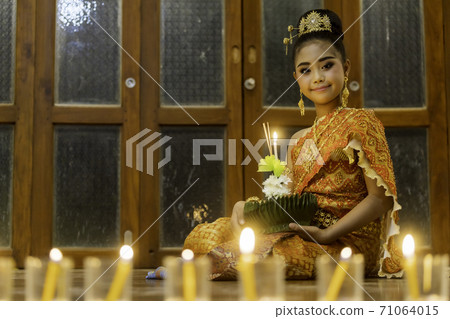 A portrait of a young student, an Asian woman wearing a traditional Thai dress t 71064015