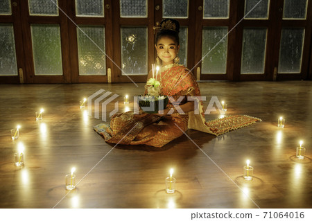 A portrait of a young student, an Asian woman wearing a traditional Thai dress t 71064016