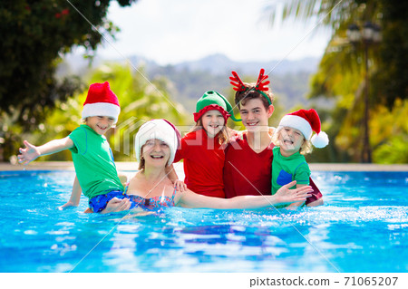 Family Christmas vacation. Kids in swimming pool. 71065207
