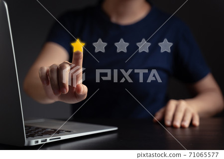 Woman using laptop present star icon hologram effect. Woman using laptop present star icon hologram effect. 71065577