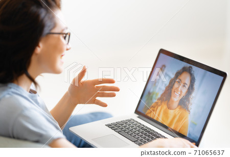 woman is using laptop for remote conversation woman is using laptop for remote conversation 71065637