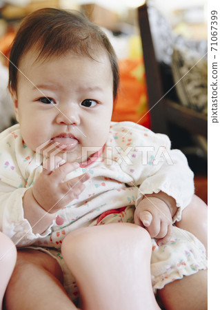 Baby sitting in a chair Baby sitting in a chair 71067399