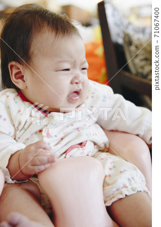 Baby sitting in a chair 71067400