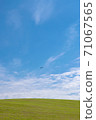 An airplane flying over Biei Hill 71067565